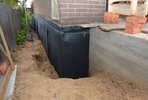 Happy homeowners after waterproofing job in Ridge